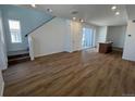 Bright living space with hardwood floors, a staircase, and a sliding glass door at 6648 N Nepal Ct, Aurora, CO 80019