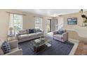 Bright and airy living room featuring neutral tones, a comfortable sofa, and stylish decor at 7355 S Knolls Way, Centennial, CO 80122