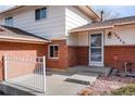 Close-up of the home's entry, showcasing the brick exterior, white trim, and a welcoming porch at 10620 King Ct, Westminster, CO 80031