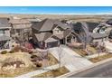 Spacious home with mature landscaping, attached garage, and long driveway in a suburban community at 7680 S Blackstone Pkwy, Aurora, CO 80016