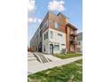 Modern townhome with mixed material facade, including concrete, wood, and metal accents at 1836 Grove St # 108, Denver, CO 80204