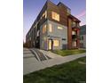 Modern townhome with mixed material facade, including concrete, wood, and metal accents at 1836 Grove St # 108, Denver, CO 80204