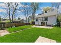 Large backyard with green grass, wood fence and access to an accessory dwelling unit at 1850 S Williams St, Denver, CO 80210