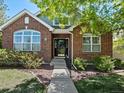 Charming brick home featuring a well-maintained front yard and inviting entrance at 6900 W Grant Ranch Blvd # 49, Littleton, CO 80123