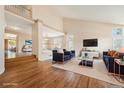 Sunlit living room with hardwood floors, vaulted ceilings, and an open layout perfect for entertaining guests at 10155 Charissglen Ln, Littleton, CO 80126