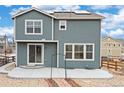 View of backyard with patio and desert landscaping, featuring solar panels on the roof at 12777 Clearview St, Firestone, CO 80504