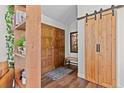 Inviting entryway featuring wood accents and a sliding barn door, combining rustic charm with modern design at 7888 S Magnolia Way, Centennial, CO 80112