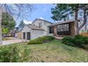 Two-story home with well-kept lawn, modern paint scheme, and mature trees creates a picturesque scene at 7888 S Magnolia Way, Centennial, CO 80112