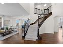 Elegant foyer with hardwood floors, staircase with wrought iron railings, and open view to the living spaces at 1150 Maddox Ct, Broomfield, CO 80023