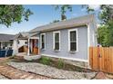 Side view of a well-maintained house featuring window boxes and stone path leading to the cozy front porch at 1448 Depew St, Lakewood, CO 80214