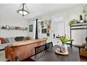 Bright living area with hardwood floors, dining table, a comfortable sofa and stylish decorative accents at 1448 Depew St, Lakewood, CO 80214