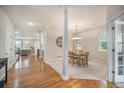 Open-concept home with dining area, wooden floors, white columns and lots of natural light at 6092 S Ouray St, Aurora, CO 80016