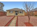 Charming brick home with well-maintained front yard and mature tree at 3020 Niagara St, Denver, CO 80207