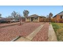 Street view of a cozy home with tidy red rock yard at 3020 Niagara St, Denver, CO 80207