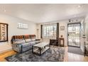Inviting living room with a couch, natural light, decorative rug, and stylish accents at 3020 Niagara St, Denver, CO 80207