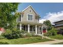 Beautiful two-story home featuring a lovely front porch and well-maintained lawn at 3354 Wabash St, Denver, CO 80238
