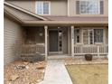 Inviting covered front porch with decorative details and manicured landscaping welcomes you home at 11254 Oakland Dr, Commerce City, CO 80640