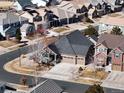 An aerial view of a residential neighborhood featuring well-maintained homes and tree-lined streets at 22647 Hopewell Ave, Parker, CO 80138