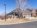 Well-maintained home with a charming front porch and a two-car garage in a suburban setting at 22647 Hopewell Ave, Parker, CO 80138