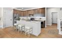 Modern kitchen with stainless steel appliances, an island with seating, and elegant cabinetry at 4888 Noris Ave, Morrison, CO 80465