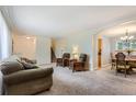 Comfortable living room with carpet, neutral walls and a staircase leading to the upper level at 13123 Spica Dr, Lone Tree, CO 80124