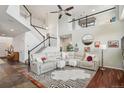 Open living room with high ceilings, a staircase, and a plush sectional sofa creating a comfortable gathering space at 26404 E Caley Dr, Aurora, CO 80016