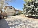 Exterior side view of single Gathering home with brick and siding details plus attached garage and a spacious driveway at 4060 Shaw Blvd, Westminster, CO 80031
