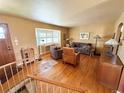 Spacious living room featuring hardwood floors, large windows, and comfortable seating arrangements at 4060 Shaw Blvd, Westminster, CO 80031