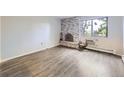 Inviting living room with a fireplace, hardwood floors, and a large window offering views at 1008 N Corona St # 403, Denver, CO 80218