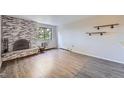 Spacious living room showcases a brick fireplace, hardwood floors, and great natural light at 1008 N Corona St # 403, Denver, CO 80218