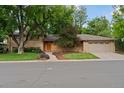 Charming single-Gathering home featuring a brick exterior, mature trees, and two-car garage at 3190 S Detroit St, Denver, CO 80210