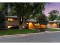 Attractive home with a brick front, well-lit windows, and professional landscaping at 3190 S Detroit St, Denver, CO 80210