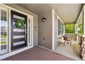 Inviting front porch with a stylish door, a wreath, seating, and a cozy space for relaxation and enjoying the outdoors at 860 Quintana Ln, Erie, CO 80516