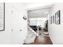 Bright entryway featuring hardwood floors, carpeted stairs, and ample natural light at 203 S Oak Hill St, Aurora, CO 80018