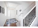 Bright entryway featuring hardwood floors, carpeted stairs, and ample natural light at 203 S Oak Hill St, Aurora, CO 80018