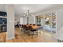 Elegant dining room featuring hardwood floors, modern light fixture, and sliding glass doors to the backyard at 2999 S Adams St, Denver, CO 80210