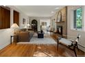 Inviting living room with a brick fireplace, hardwood floors, and an open layout at 1985 Union St, Lakewood, CO 80215