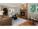 Inviting living room with a brick fireplace, hardwood floors, and an open layout at 1985 Union St, Lakewood, CO 80215