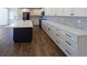 Bright kitchen with white cabinetry, quartz countertops, stainless appliances, and a large island at 14546 Pine View Rd, Larkspur, CO 80118