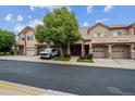 A well-maintained exterior showing the multiple garages and entrance of this residential complex at 10725 Eliot Cir # 102, Denver, CO 80234