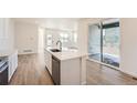 Bright eat-in kitchen features a large island, stainless steel appliances, and sliding glass doors at 1294 S Algonquian St, Aurora, CO 80018