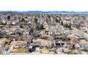 Overhead shot of a community neighborhood, emphasizing the property's setting with mountain views in the distance at 7559 Jay Ct, Arvada, CO 80003