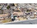 Aerial view of a well-maintained property, highlighting the home's position among mature trees and neighborhood charm at 7559 Jay Ct, Arvada, CO 80003