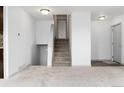 Bright, open-concept staircase leading to the upper level, freshly painted white at 8757 Estes Ct, Arvada, CO 80005