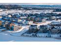 Panoramic aerial view of a neighborhood covered in snow, showcasing the mountain and city views at 6612 Merrimack Dr, Castle Pines, CO 80108