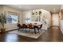 Dining room with a rustic wood table and leather chairs at 6612 Merrimack Dr, Castle Pines, CO 80108