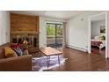 Cozy living room with fireplace, hardwood floors, and sliding doors to balcony at 2630 Juniper Ave # 37-5, Boulder, CO 80304