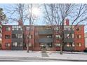 Attractive brick apartment building with well-maintained landscaping and a welcoming entrance at 534 E 7Th Ave # 205, Denver, CO 80203