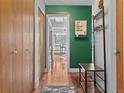 Hallway with wood floors, a view into the dining room and kitchen, and ample closet space at 534 E 7Th Ave # 205, Denver, CO 80203