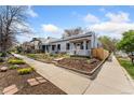 Charming home with blue exterior, landscaped front yard, and welcoming curb appeal at 3059 N Humboldt St, Denver, CO 80205